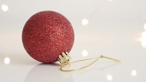 Tilting on bauble with sequins close-up 4K 2160p 30fps UltraHD footage - Red Christmas ornament and