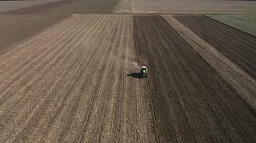 Top view of moving tractor with plow