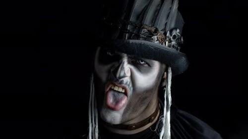Sinister Man with Skeleton Makeup Appearing From Darkness When Light Falls on Him, Making Faces