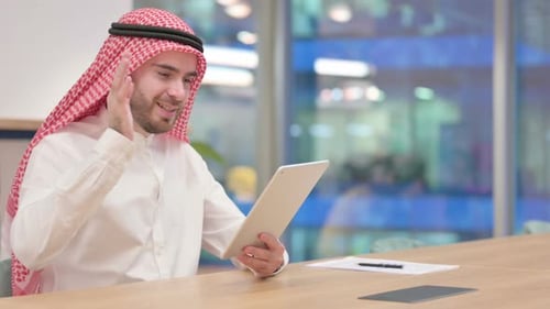 Professional Arab Businessman Doing Video Call on Tablet in Office
