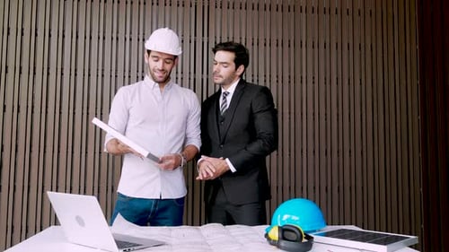 Engineer and Investor discussion about panel solar cell with laptop computer
