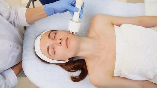 Calm Attractive Woman with Closed Eyes Getting Rf-lifting in a Beauty Salon