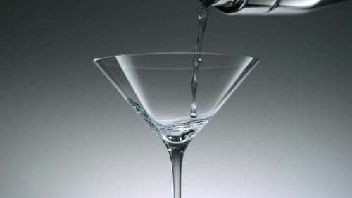 Blue Liquid Pouring into Martini Glass