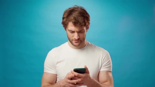 Young Adult Man Reacts to Good News on Phone