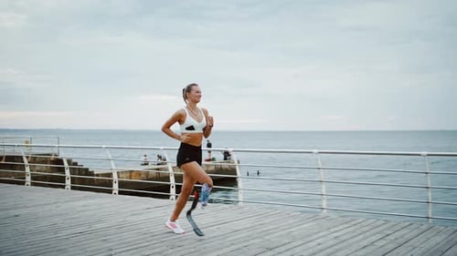 Female Runner With Prosthetic Leg on Boardwalk