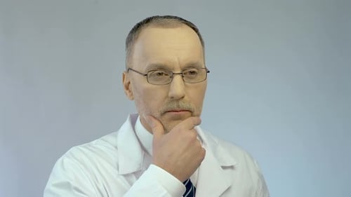 Thoughtful Doctor Thinks with Finger Up in Lab