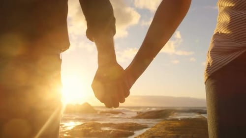 Couple walking hand in hand on the beach 4k