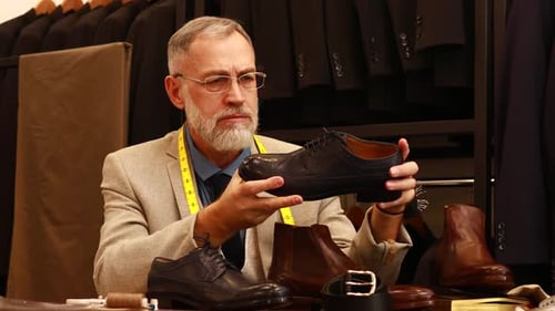 Elder Good Looking Man with Gray Beard Wear Nice Suit at Atelier Studio and Checking the Quality of