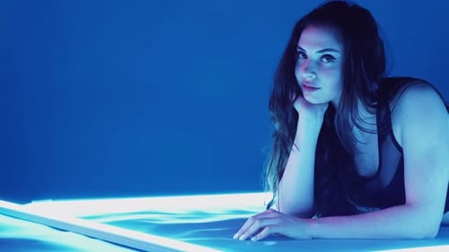 Woman Posing in Blue Lighting Studio