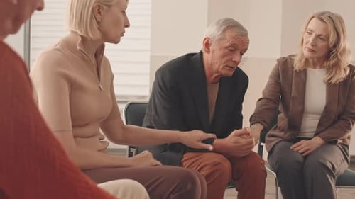 Adults Support Each Other in Group Therapy Session