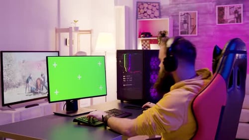 Gamer Playing Computer Game at Home