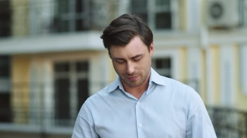 Man Puts in Wireless Earbud and Listens