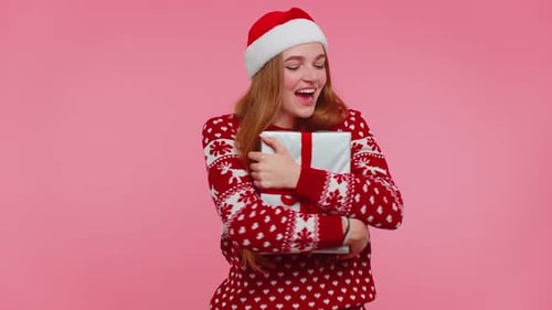 Excited Woman Receives Christmas Gift with Cheer