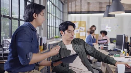 Young Adults Working Together in a Modern Office