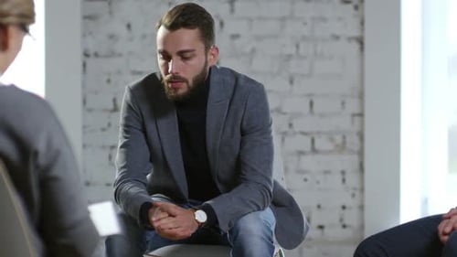 Man Speaking in Group Therapy Session