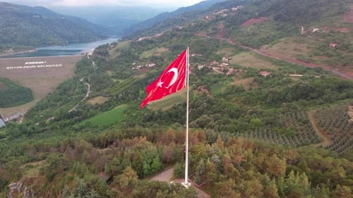 Red Flag Flying Over Green Turkish Hills