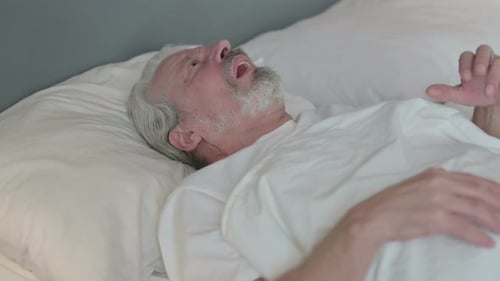 Senior Man Sleeping in Bed Snoring