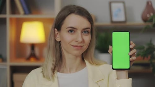 Portrait of Woman Holding Smartphone with Chroma Key Screen