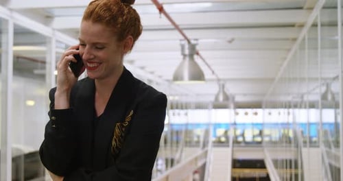 Businesswoman talking on mobile phone in office 4k
