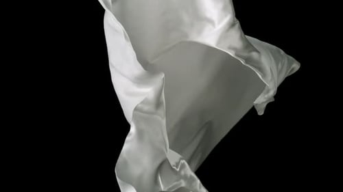 White Fabric Flowing on Black Background