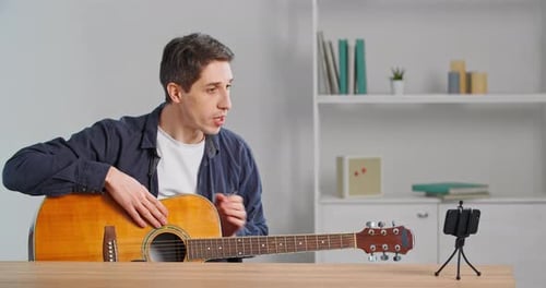 Young Adult Man Teaches Guitar Online