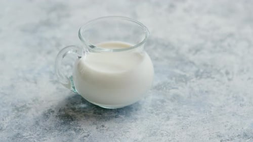 Glass Creamer Filled with Fresh, White Milk