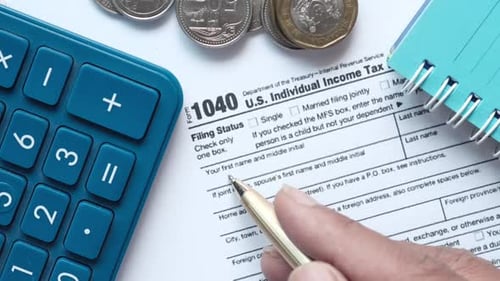 Close Up of a Tax Return Form and Pen on Table