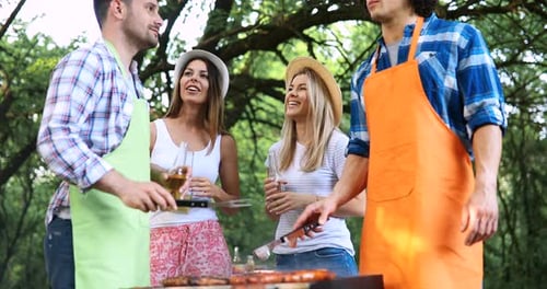 Friends Having Fun at Barbecue in a Wooded Park