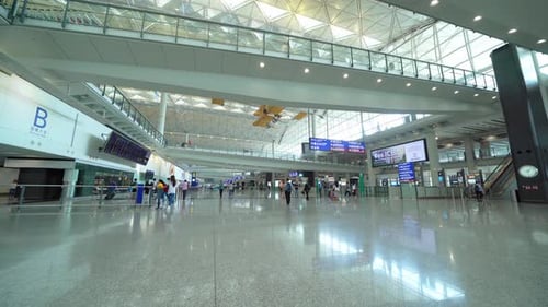 Crowd of people, passengers inside Hong Kong International Airport.