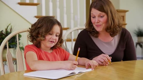 Mother and Daughter Studying Together at Home