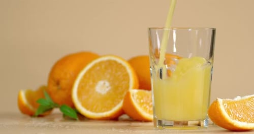 Pouring Fresh Orange Juice into a Glass