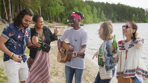 Group of Friends Enjoying a Lakeside Beach Gathering