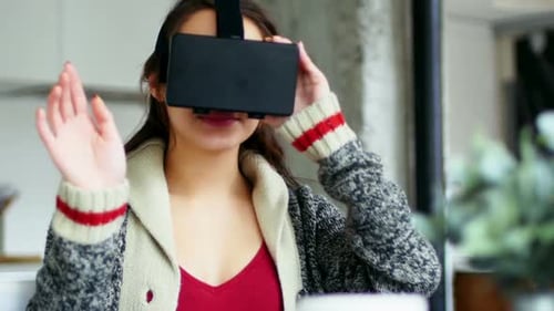 Young Woman Using VR Headset Indoors