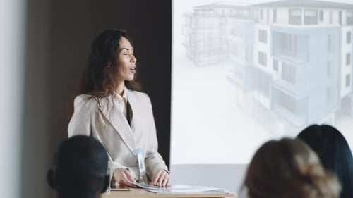 Businesswoman Giving Presentation to Audience on Architecture Conference