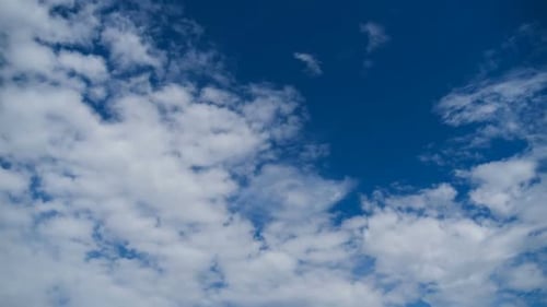 White Clouds Drifting Across Azure Blue Sky