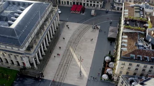 Opera house Grand Theater square with people, vehicles and trolley tram tracks, Aerial orbit reveal