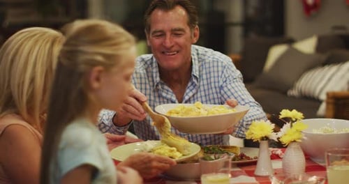 Family Enjoying Meal Together Around Table