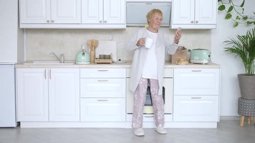 Senior Woman On Video Call In Bright Kitchen