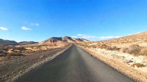 Long asphalt road and travel car movement point of view with outdoors beautiful sand desert around