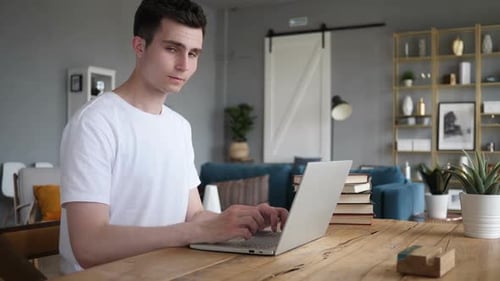 Man Working on Laptop at Home