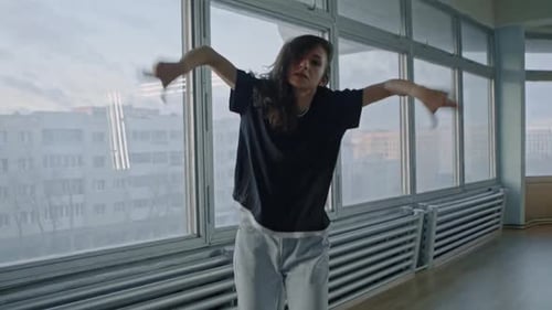 Energetic Woman Dancing in an Urban Studio