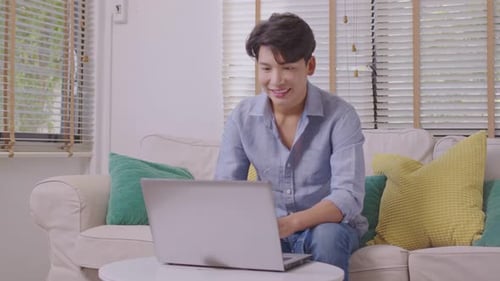 Young Adult on Laptop During Video Call Indoors