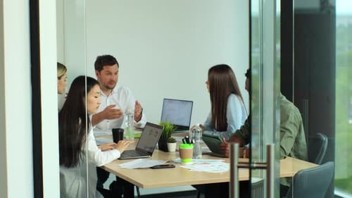 Diverse Team Involved in Teamwork in Trendy Brick Office Space
