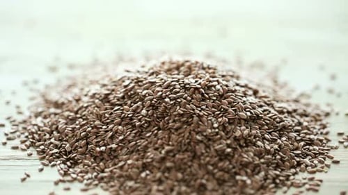 Flax Seeds with Wooden Spoon on Wooden Table