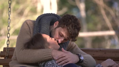 Romantic Couple Embracing and Kissing Outdoors