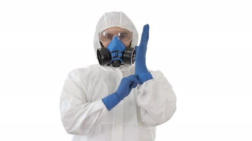 Person in Protective Suit Putting on Gloves