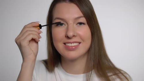 Woman Applying Mascara for a Flawless Look