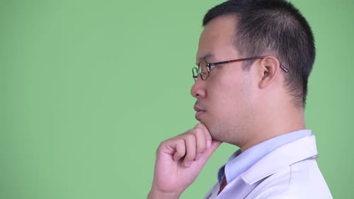 Closeup Profile View of Happy Asian Man Doctor with Eyeglasses Thinking