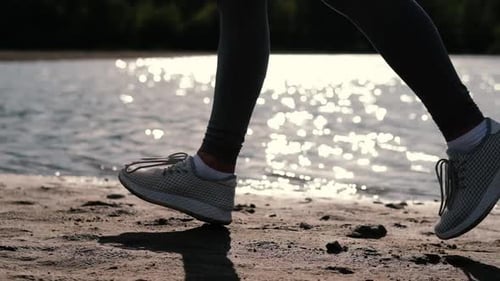 Person Running on a Sandy Beach