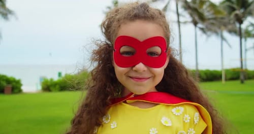 Smiling Child with Superhero Mask on Tropical Beach